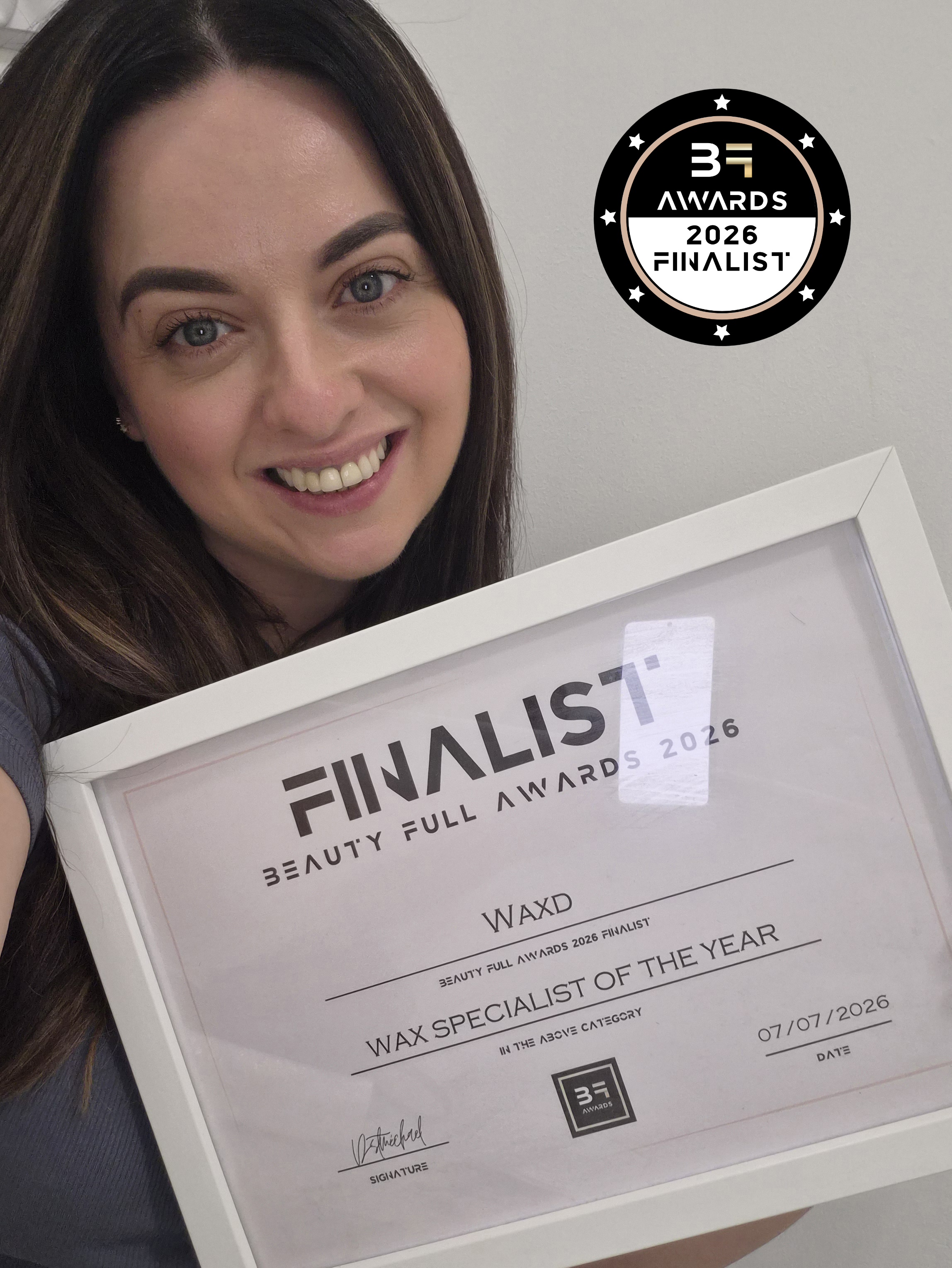 Waxd founder holding Beauty Full Awards certificate for Wax Specialist of the Year